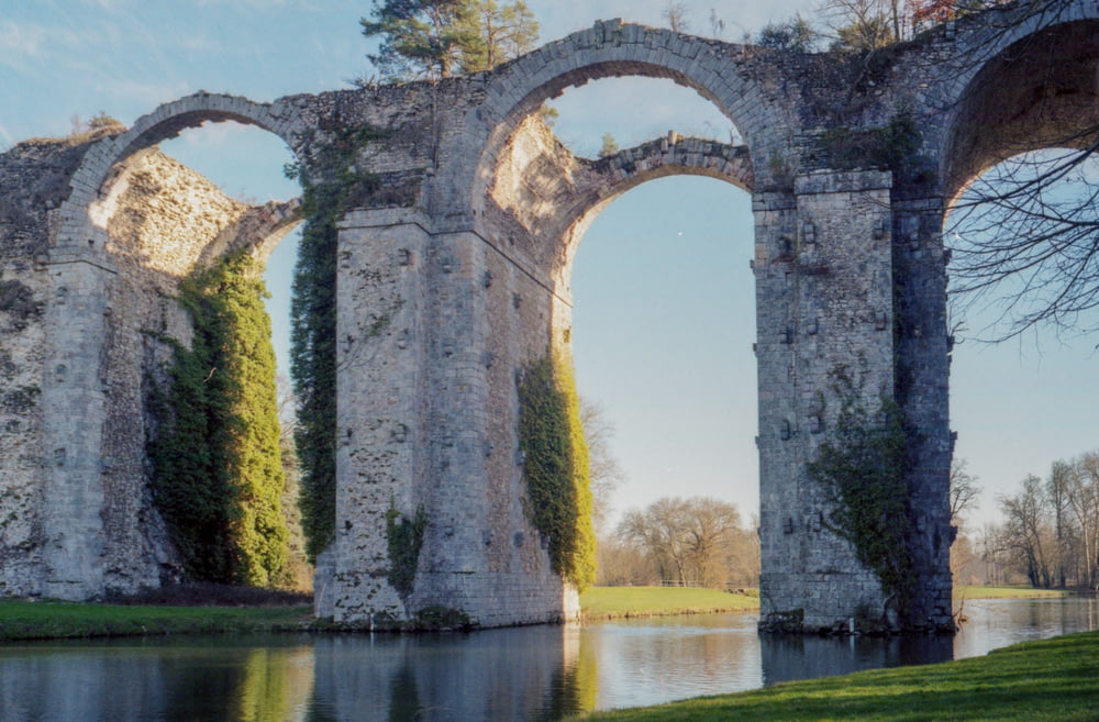 stone arches in body of water