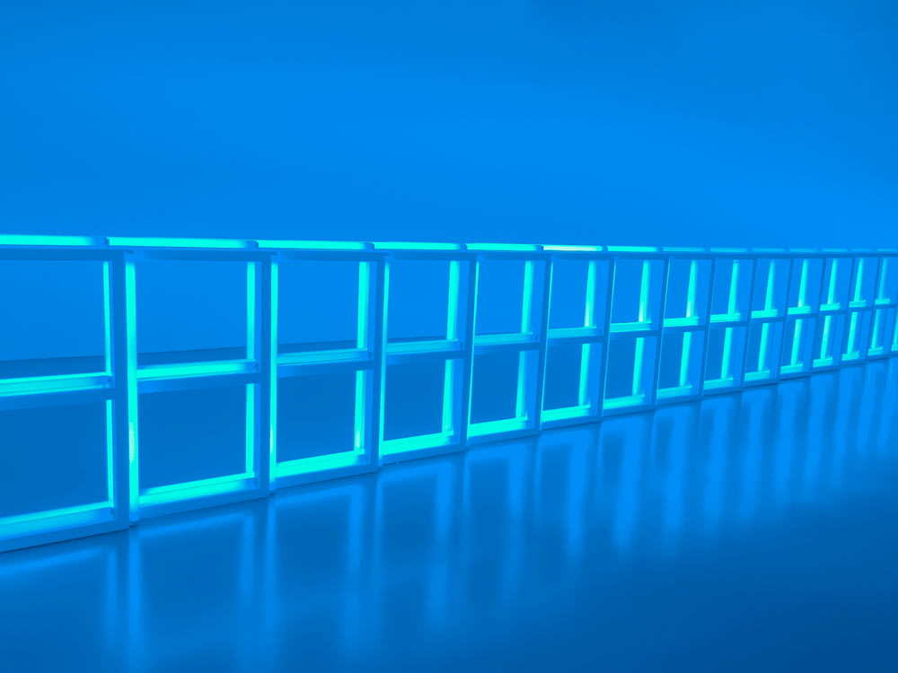 a row of blue shelves sitting on top of a blue floor