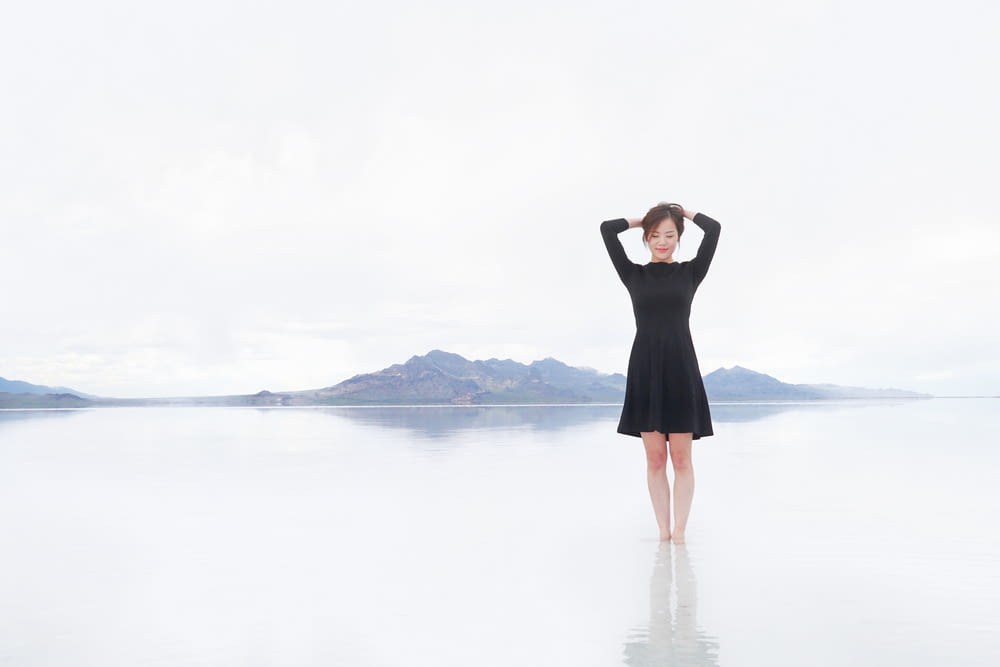 woman standing on body of water