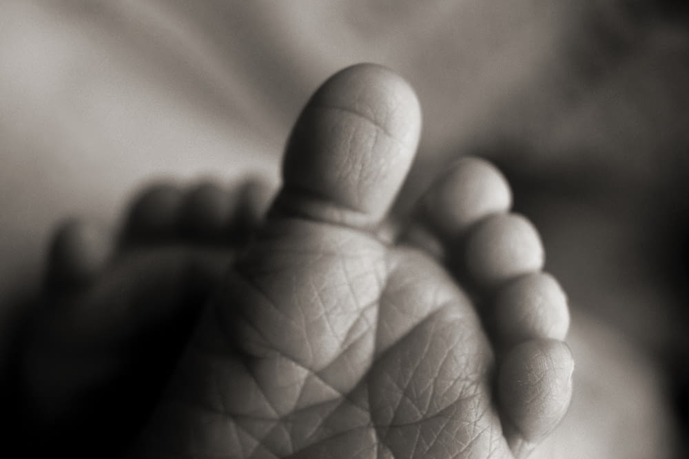 selective focus photography of baby foot sole