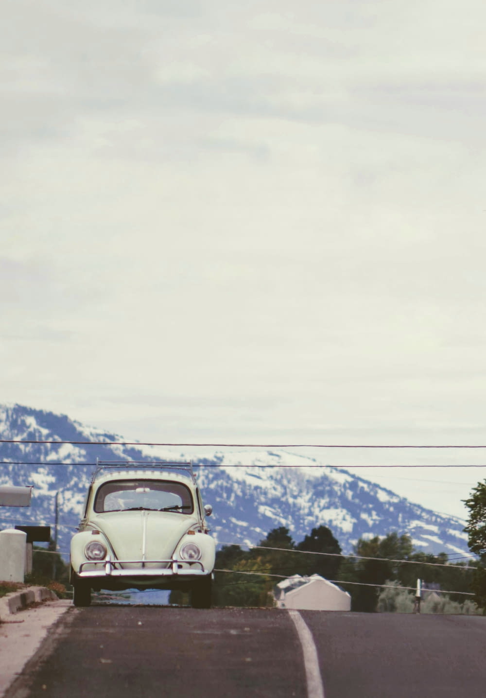 classic white Volkswagen beetle coupe at road