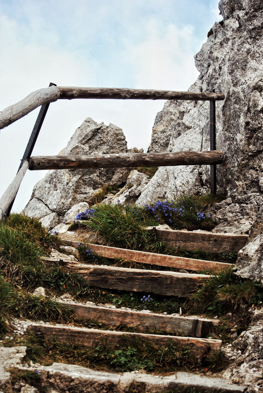 a set of wooden steps leading up to a cliff