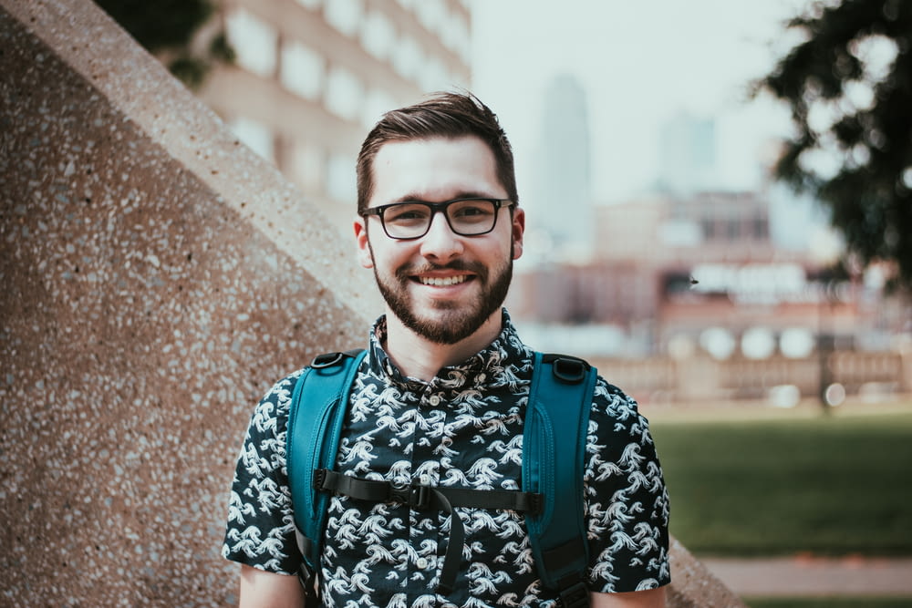 selective focus photography of man carrying backpack