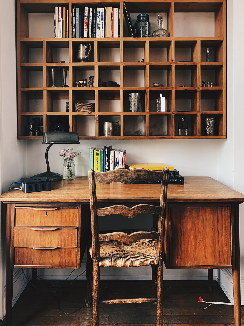 a desk with a chair and a book shelf