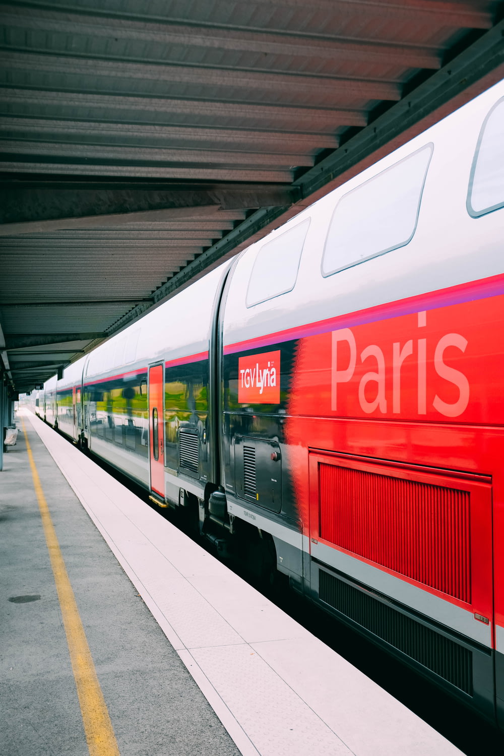 white and red Paris train on station