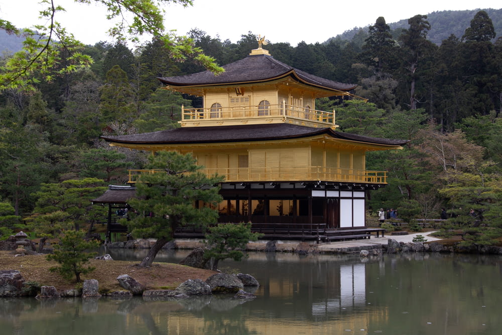 yellow 2-storey temple surrounded by trees