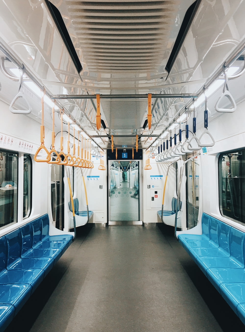 a subway car with blue seats and a door