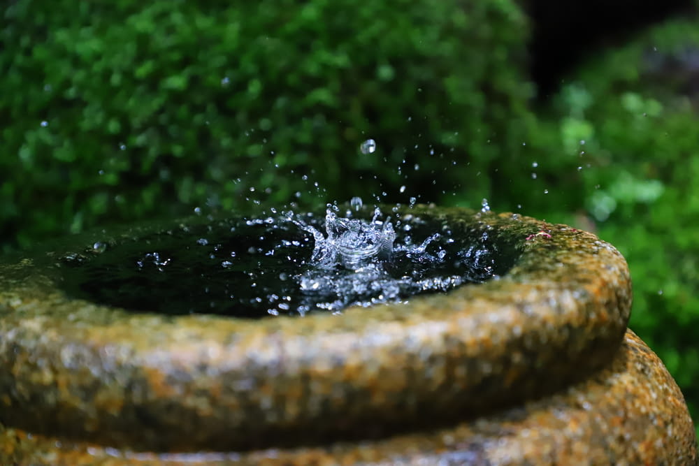 a close up of a fountain with water splashing out of it