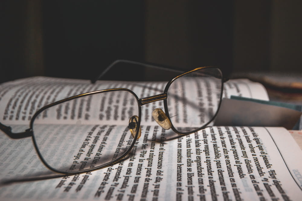 grey framed eyeglasses on book page