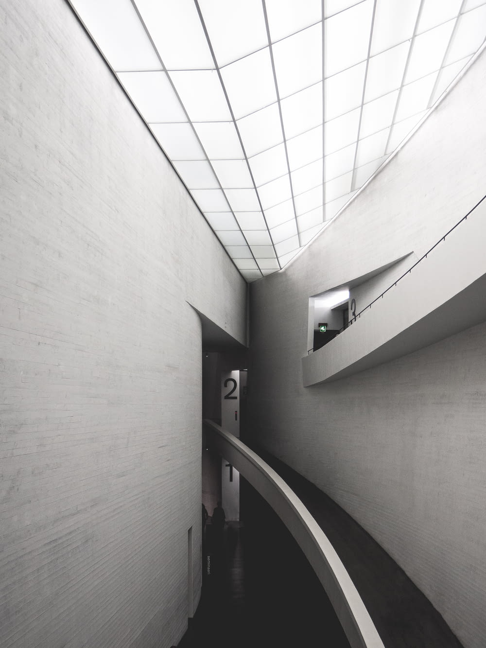 grayscale photo of empty hallway