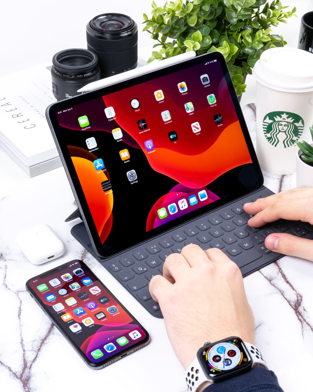 Person, die auf grauer Bluetooth-Tastatur für schwarzes Apple iPad tippt