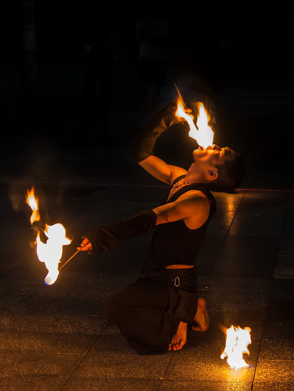 fire eating man performing