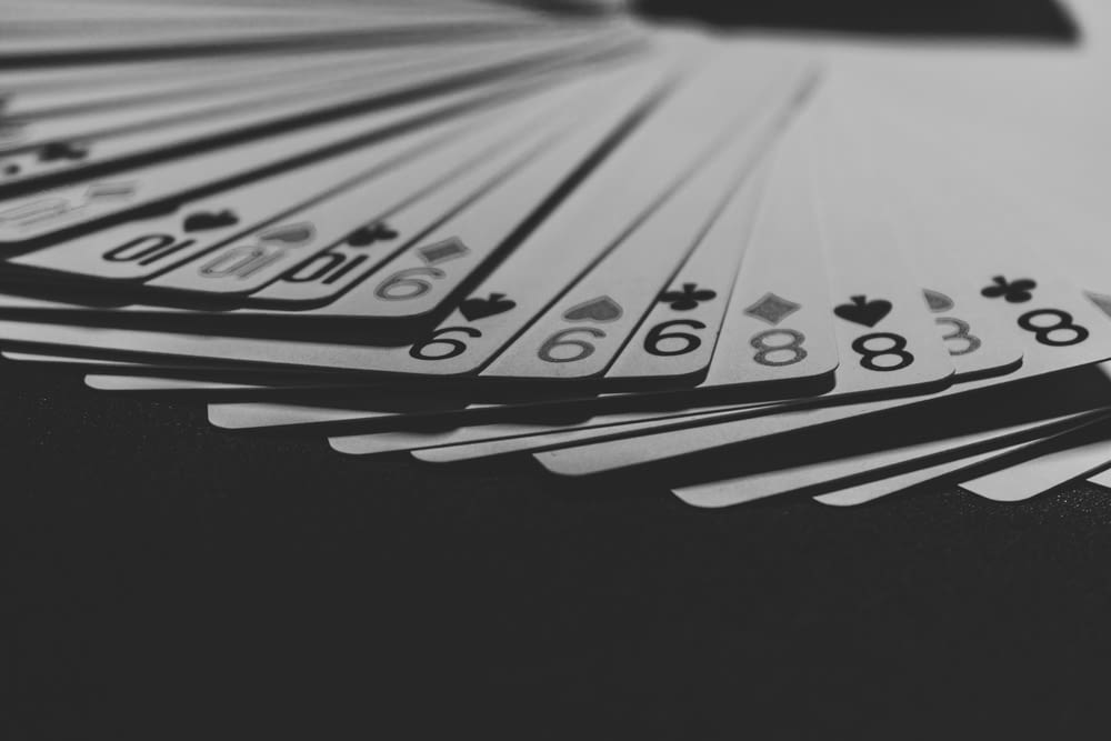 grayscale photo of a fanned playing card