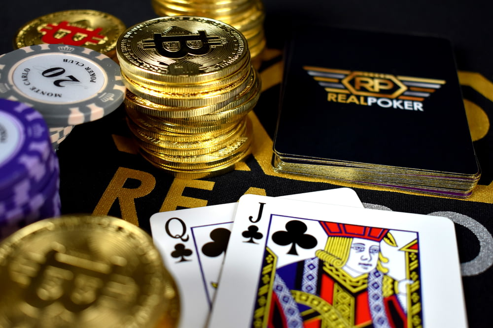 playing cards and Bitcoins near Poker set