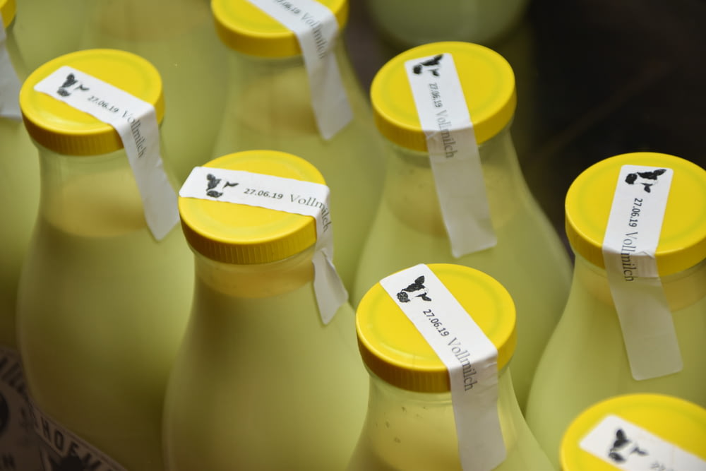milk bottles with yellow caps sealed with white tapes