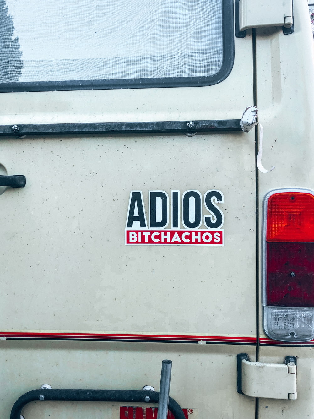 a white van with a sticker that says adios bitchachos