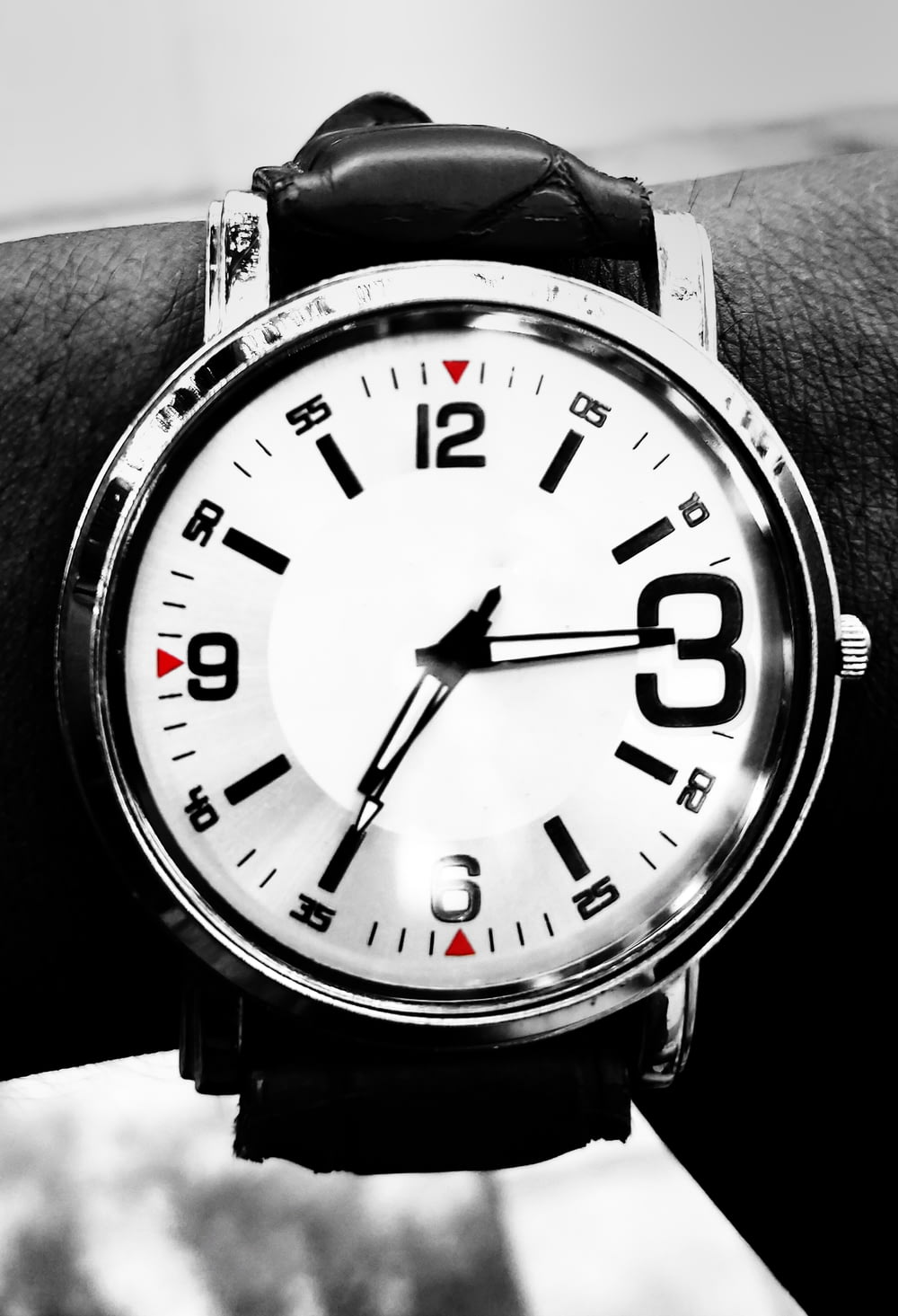 black and white analog watch with black straps