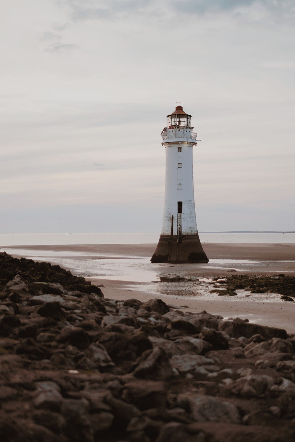 white lighthouse on seashore