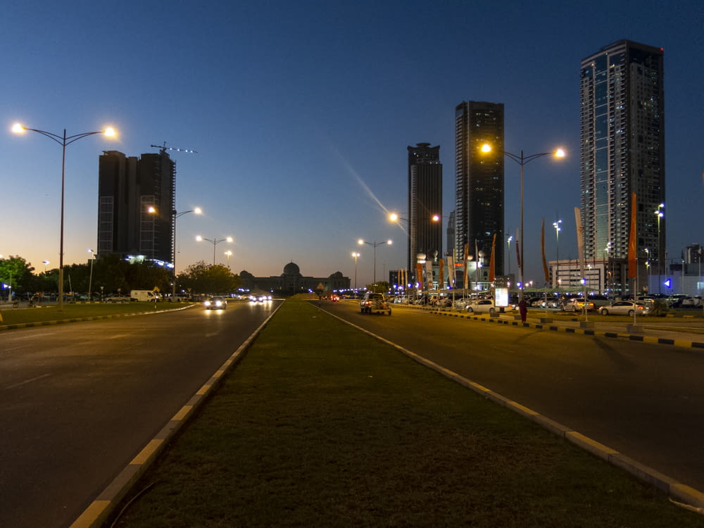 concrete road between buildings at nighttime