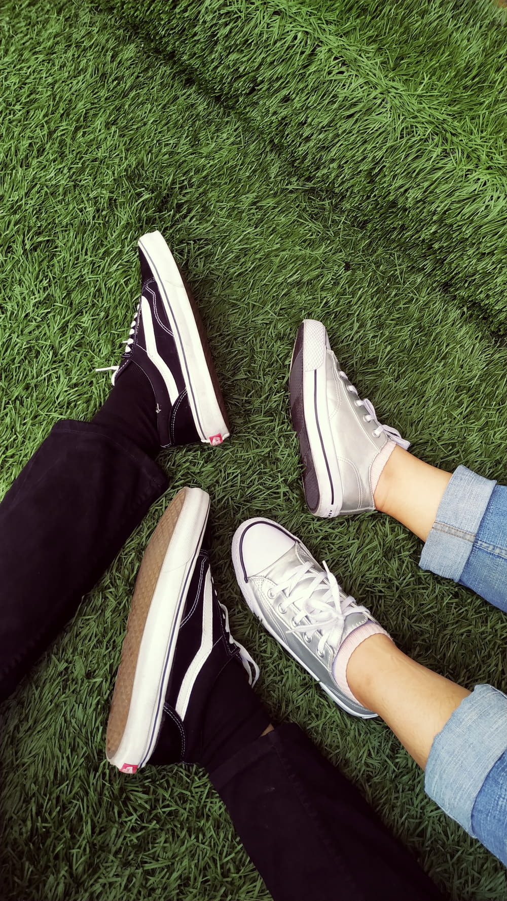 two persons wearing sneakers