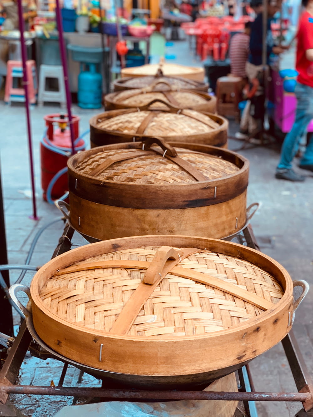 a row of baskets sitting on top of a metal rack