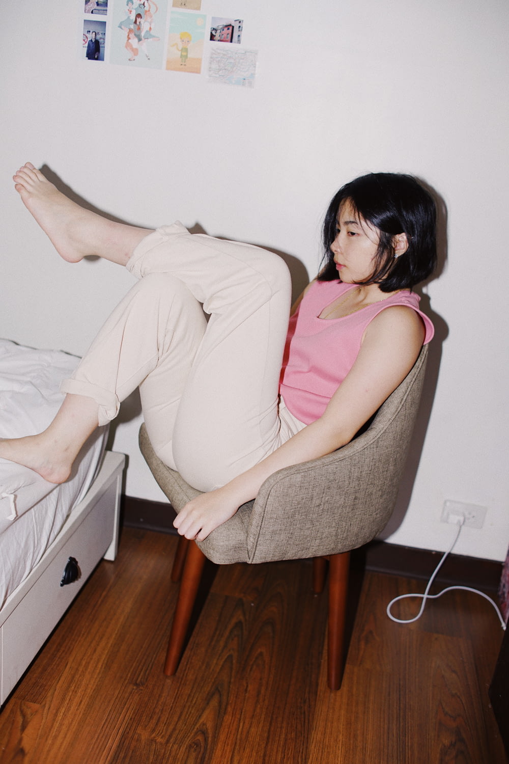 girl sitting on chair in room