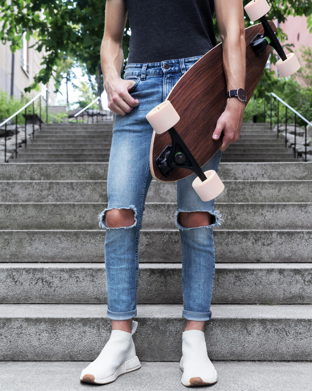 person standing with brown long board