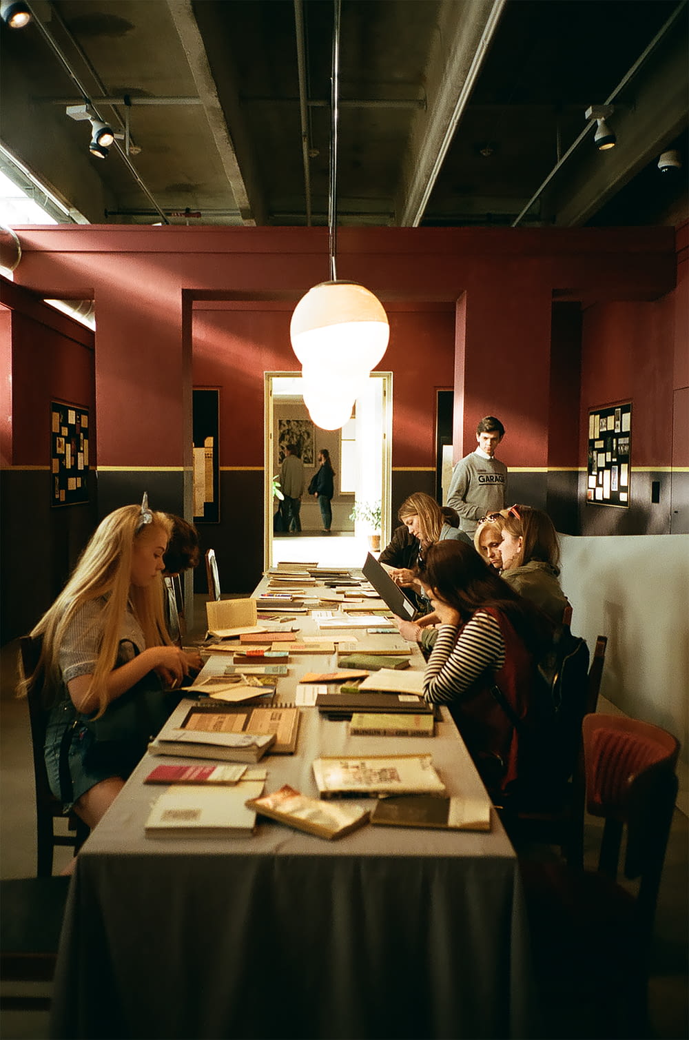 women sitting at table reading books