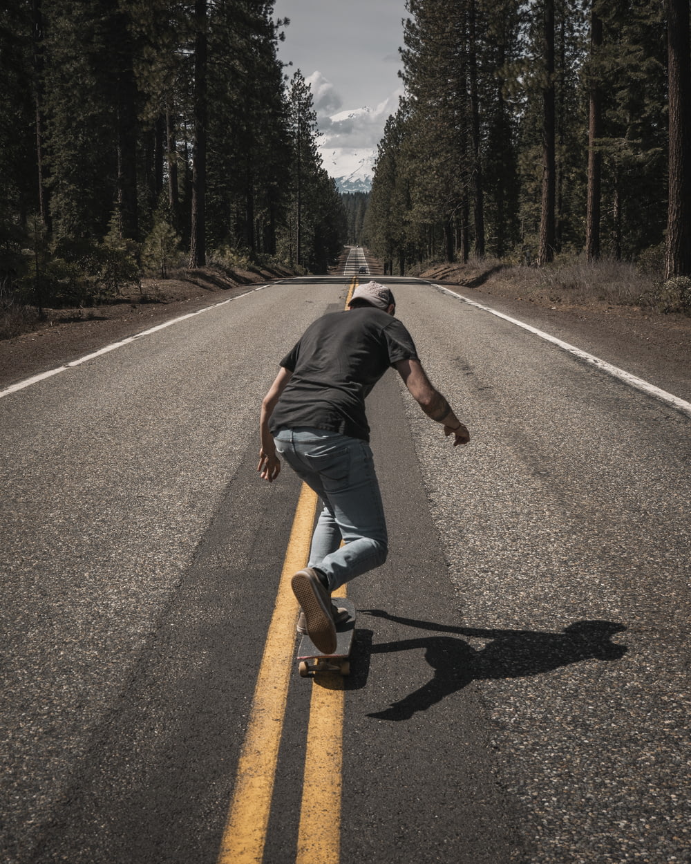 man playing skateboard on road during daytime