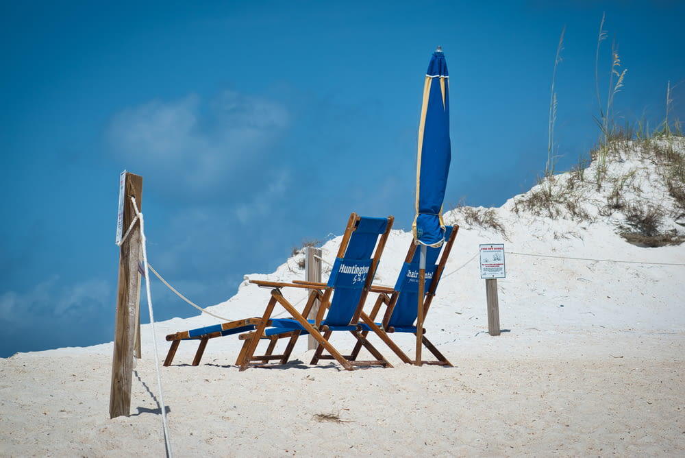 two blue loungers on beach