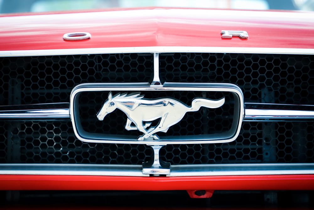 closeup photo of red and chrome Ford Mustang grille