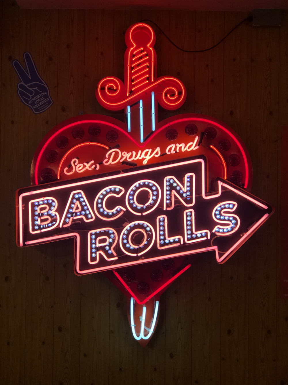 turned on Bacon Rolls neon signage on wall
