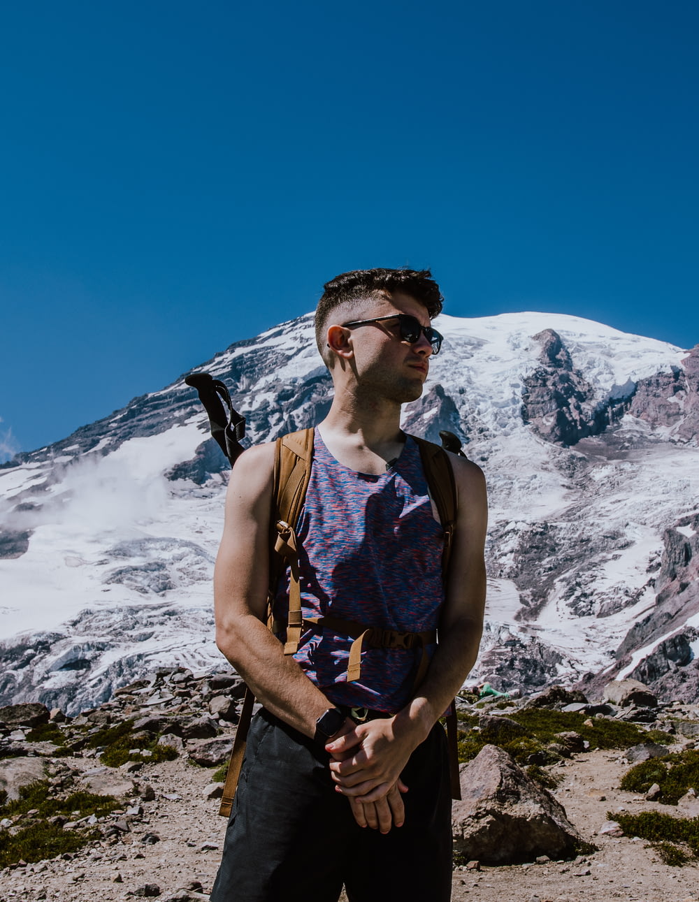 man standing in front of glacier mountain