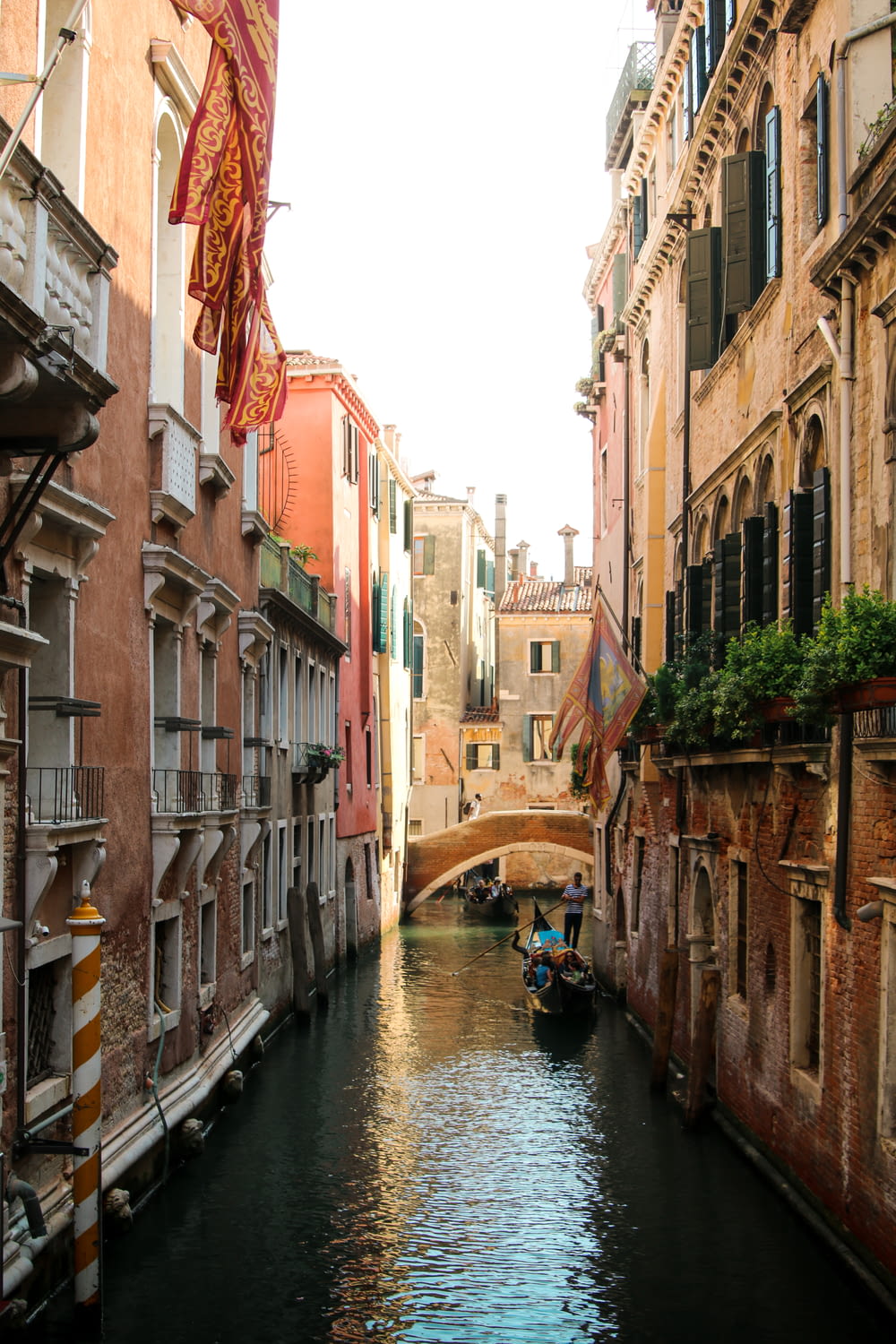 a narrow canal in a city with buildings on both sides