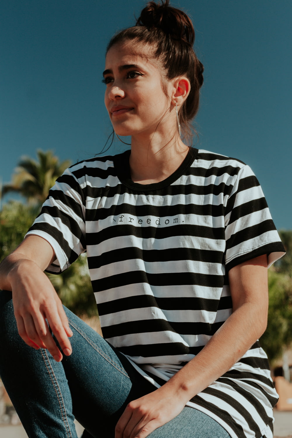 woman in white and black striped shirt