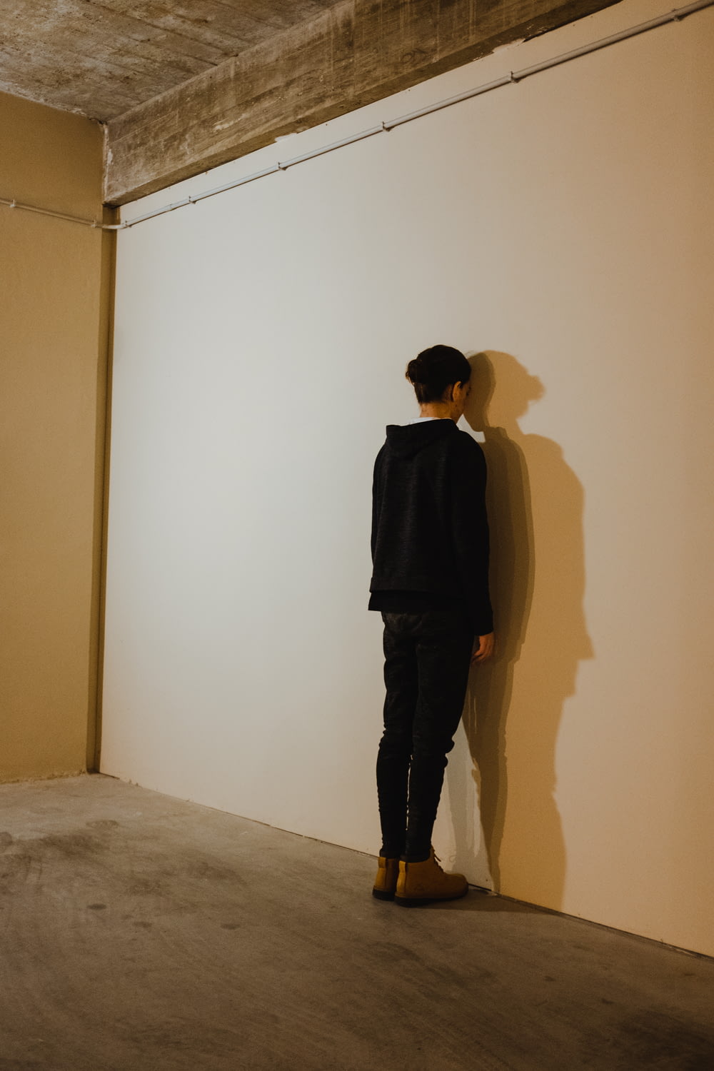 person standing beside wall