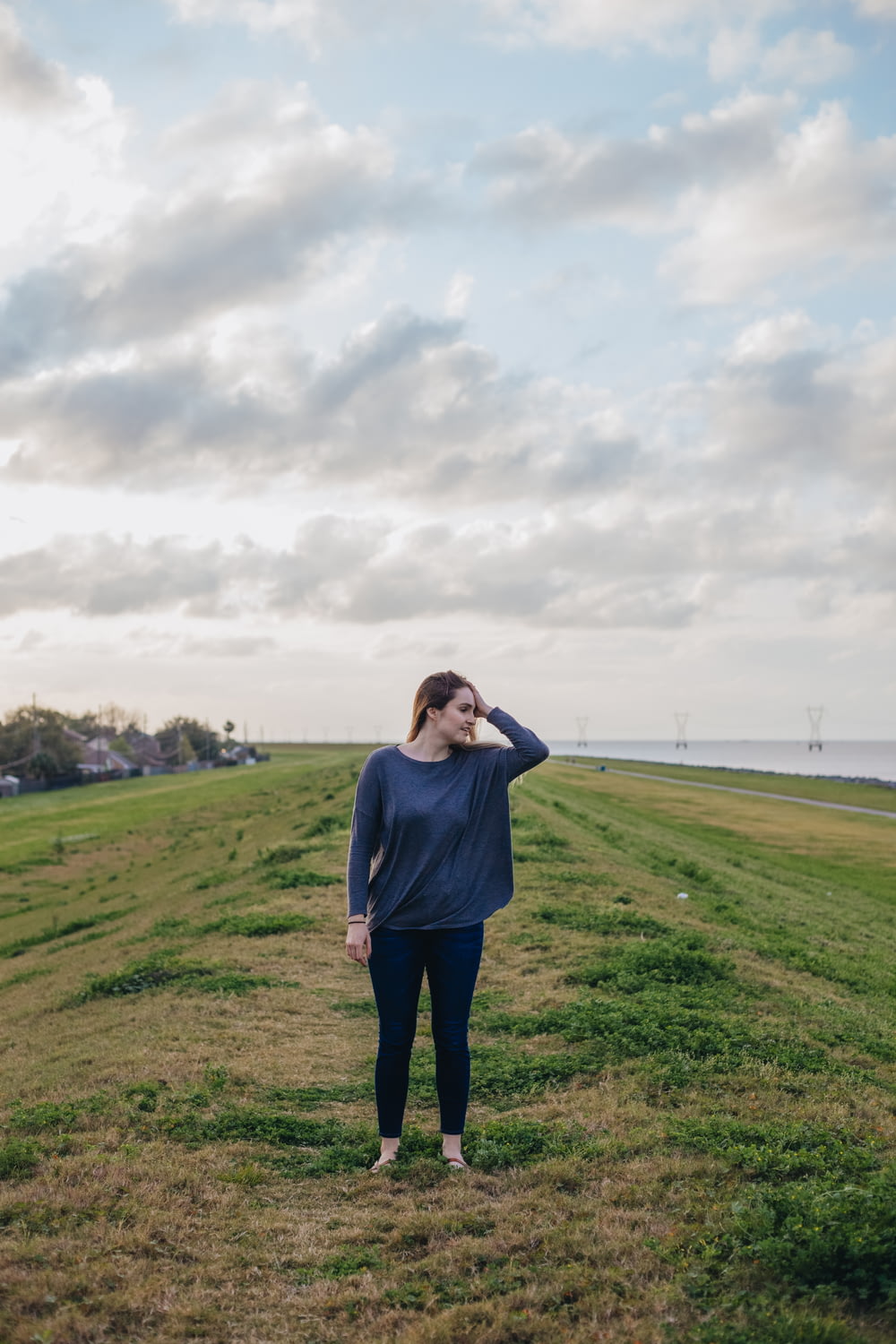 woman standing on green grass field at daytime