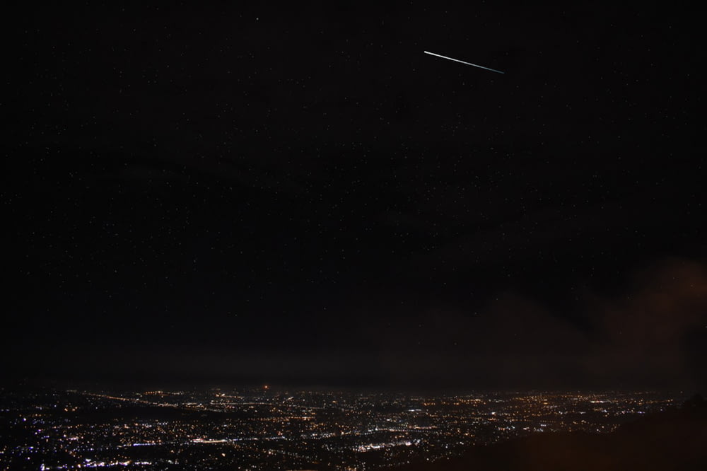 an airplane flying over a city at night