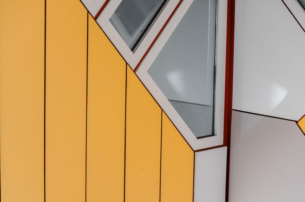 a close up of a yellow and white building