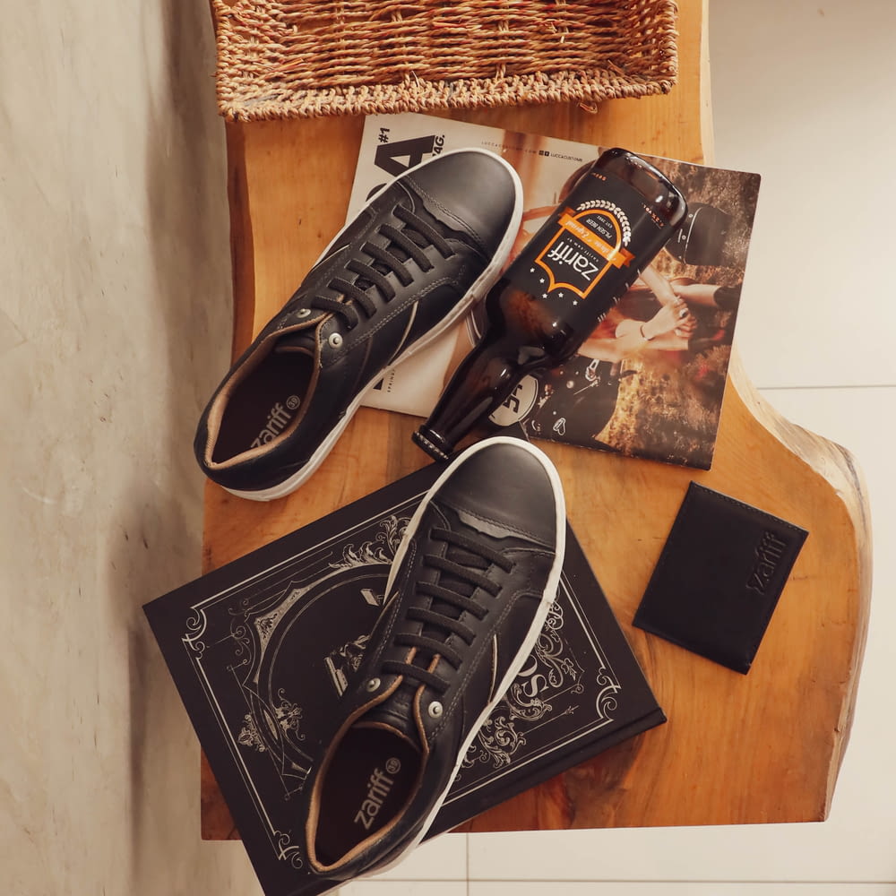pair of black leather low-top sneakers