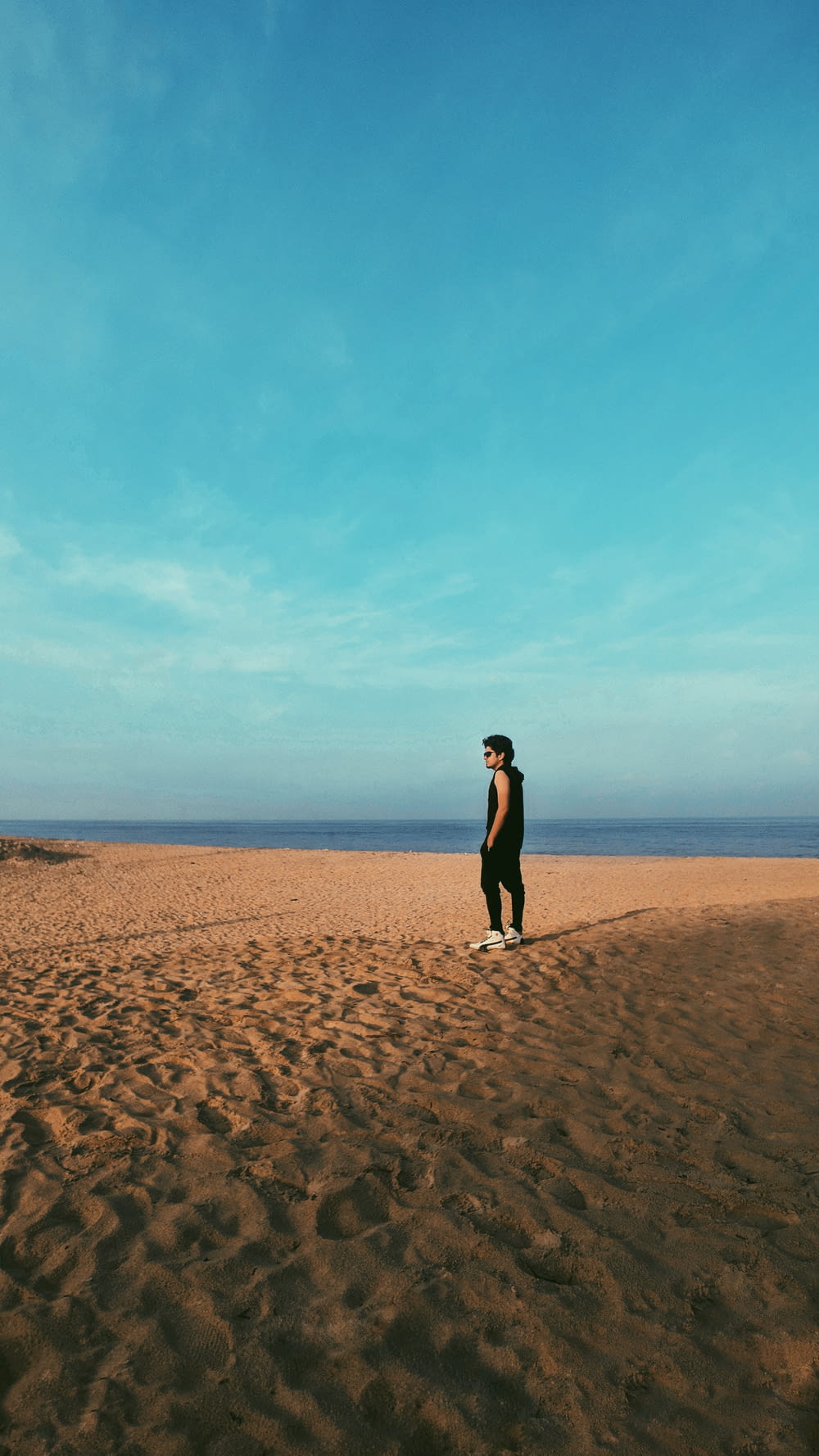 man standing on sand
