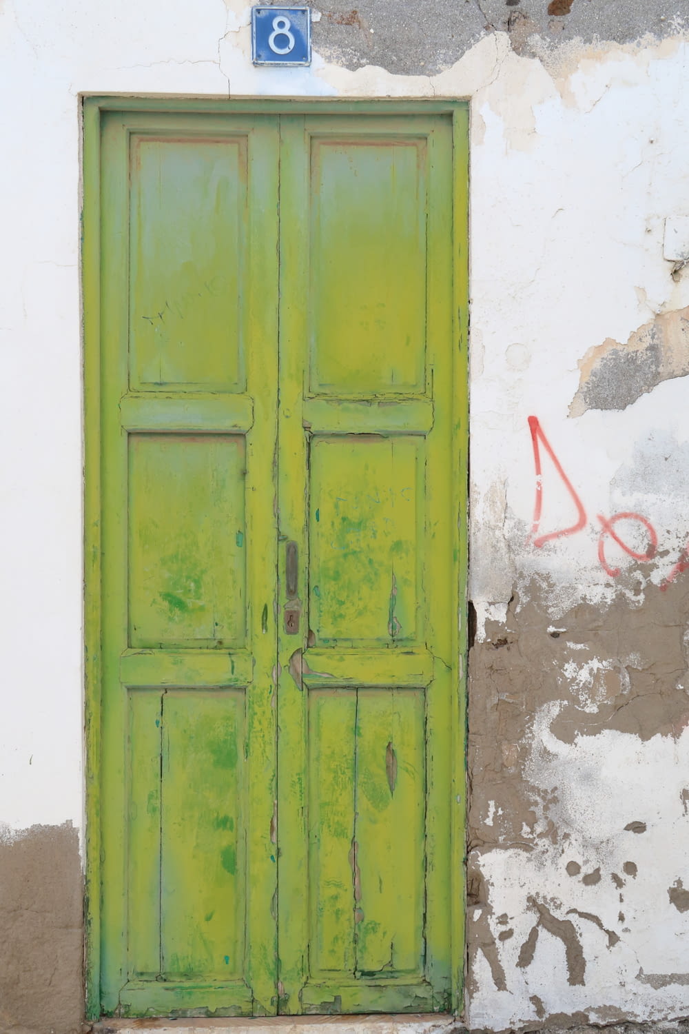 a green door on the side of a building