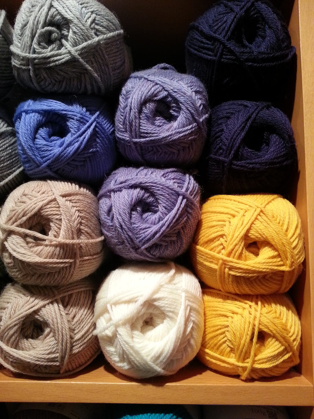 assorted-color yarn rolls piled in shelf