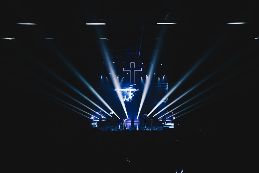 blue stage lights with cross art