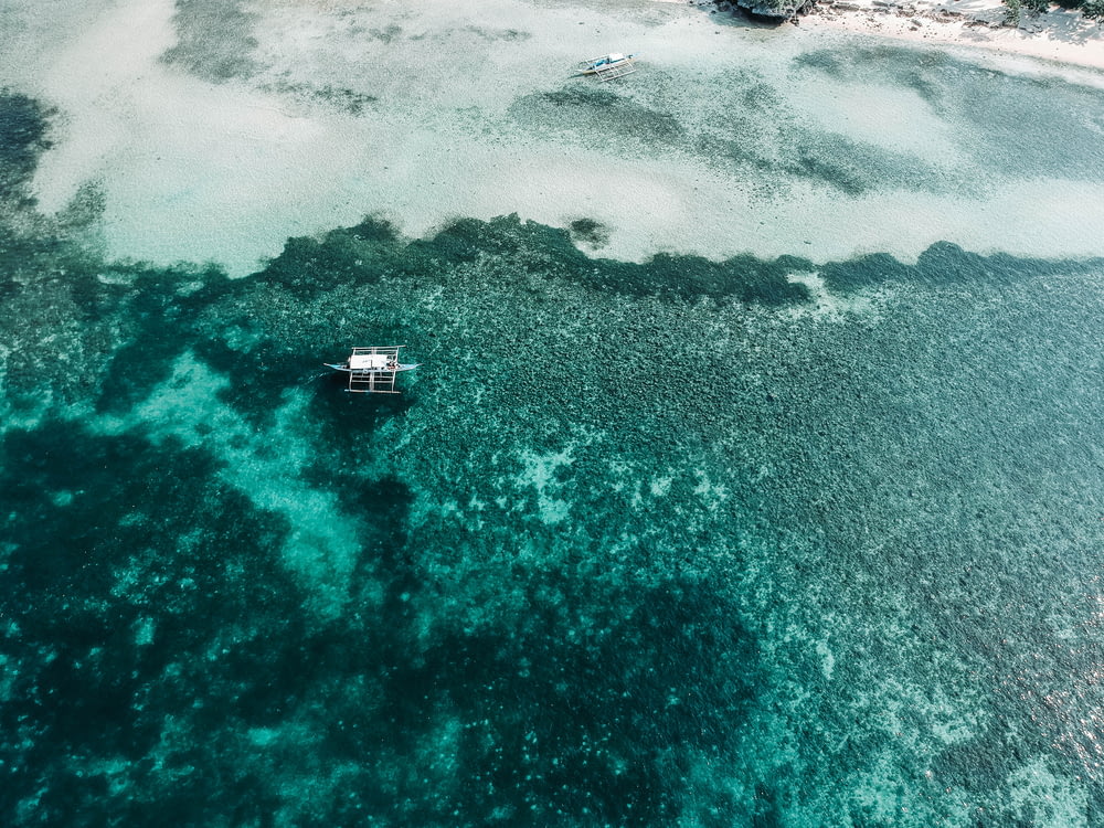 Luftaufnahme eines weißen Bootes auf einem Gewässer während des Tages
