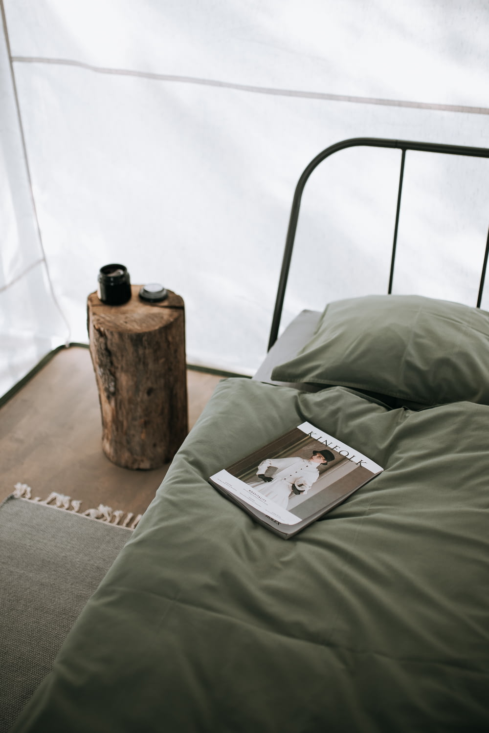 magazine in green bed near green pillow