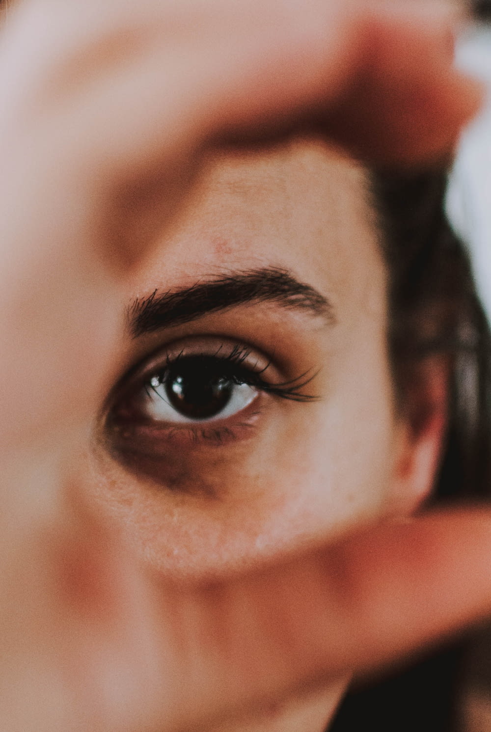 a close up of a person holding a cell phone to their eye