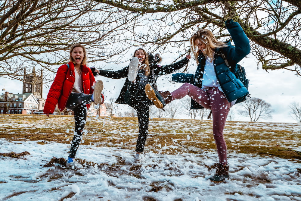 women kicking snow