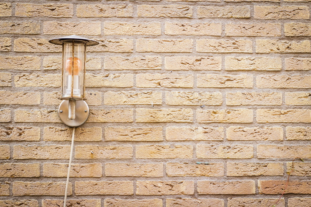 sconce lamp on brick wall