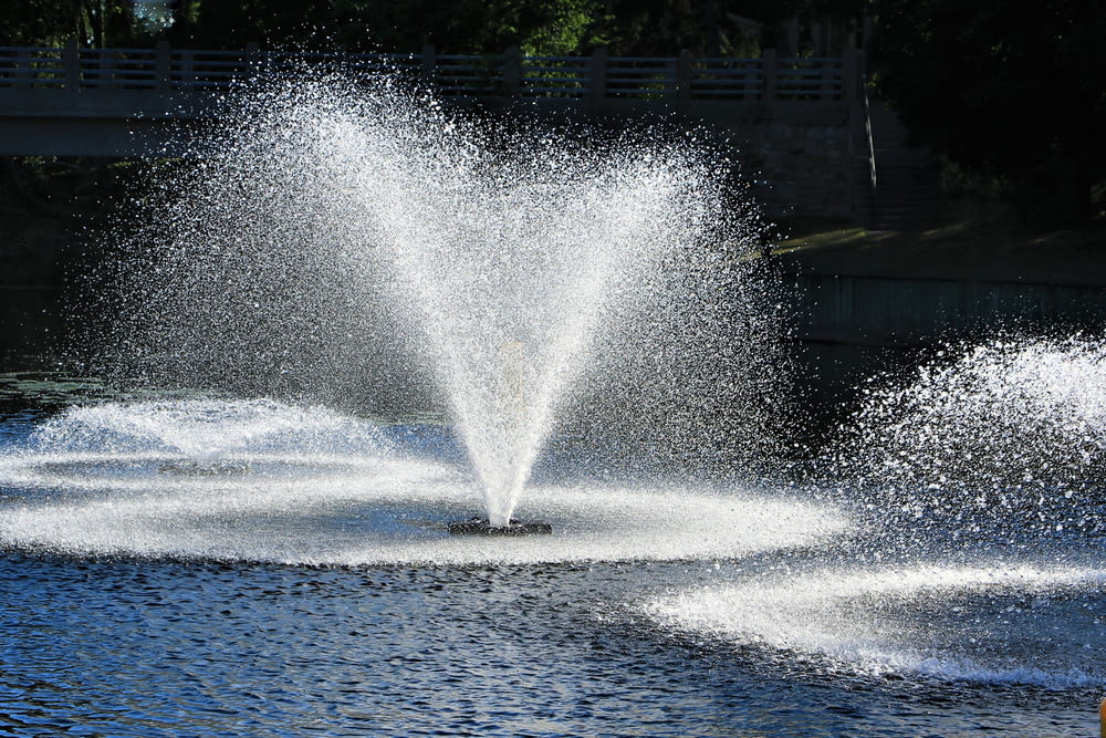 a fountain spewing water into a lake